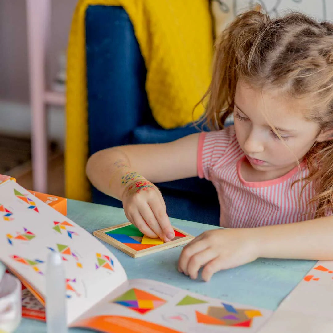 A kid playing with tangram tile from Sculpd kids ultimate bundle