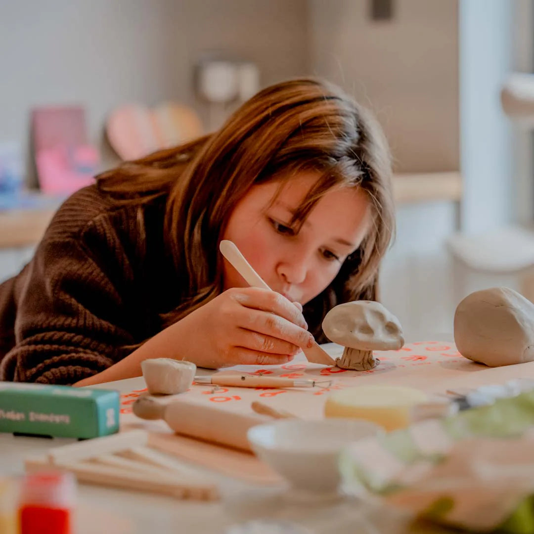 A kid sculpting her diy project with Sculpd kids pottery kit