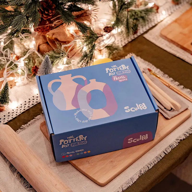 Sculpd pottery kit with pastel paints in a Christmas setting