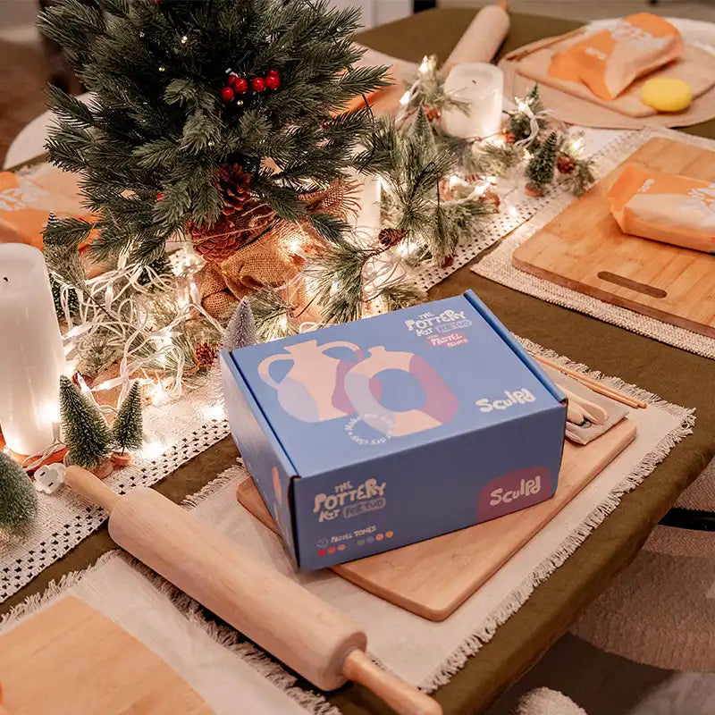 Sculpd pottery kit packaging in a cozy Christmas setting