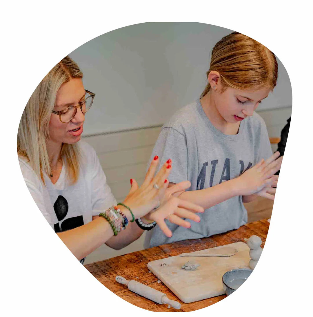 A kid with her parent enjoying Sculpd Kids Pottery Kit